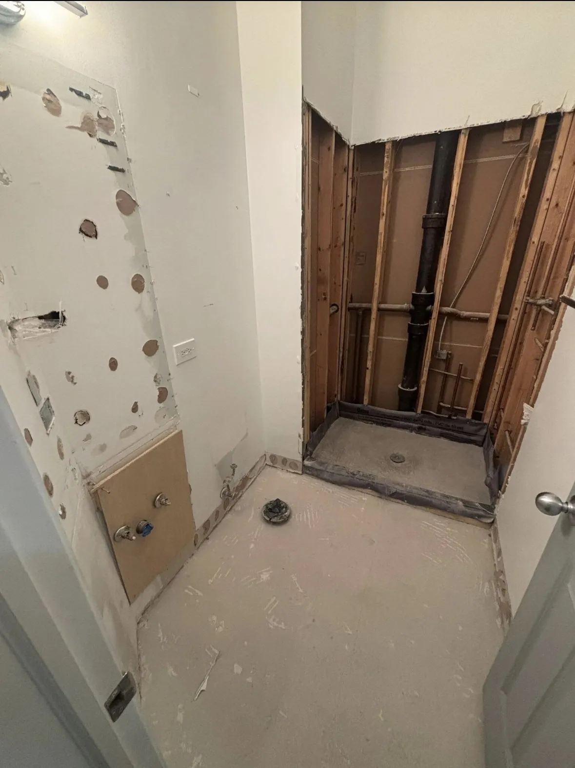 Bathroom stripped to the studs during interior demolition before the new tile build