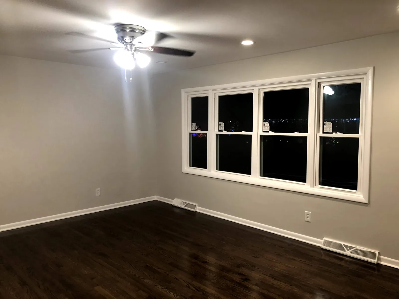 Replacement windows installed in a Chicago living room with clean painted casing and trim