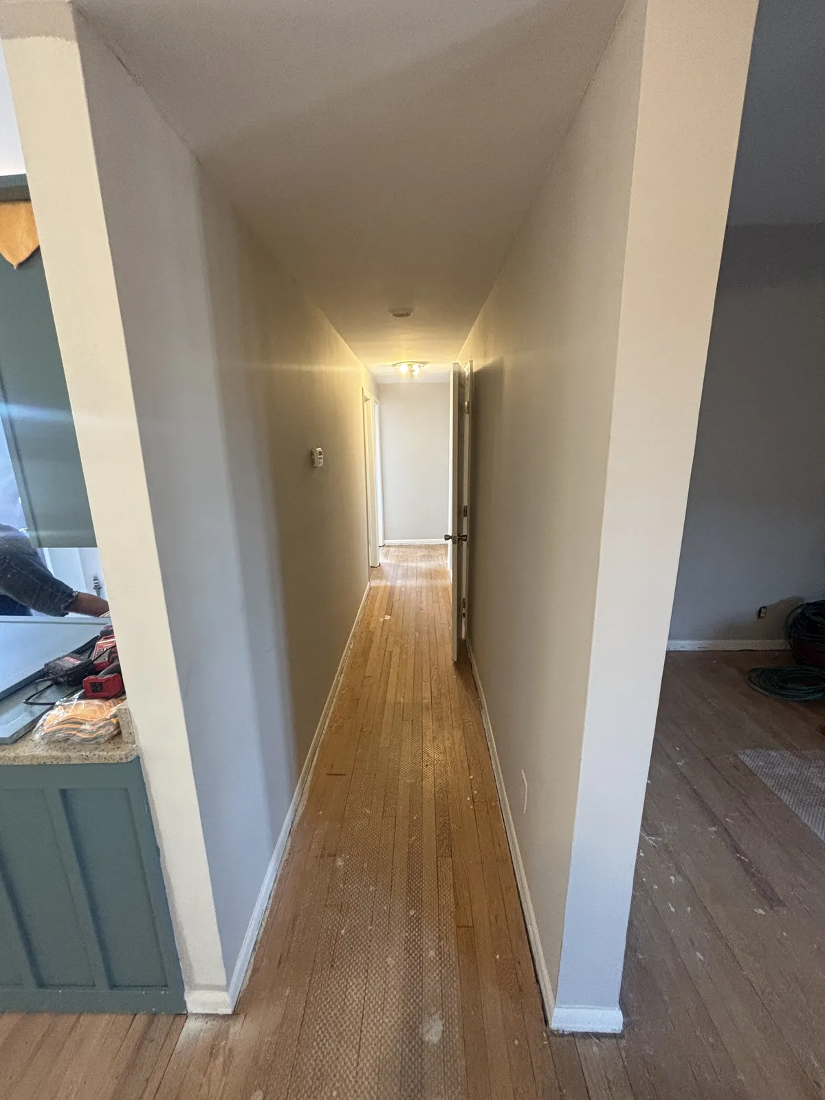 Hallway with new hardwood flooring and freshly painted walls and trim