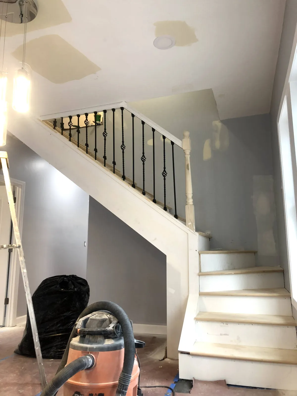 Stairway and walls in bare drywall condition before painting and finish work