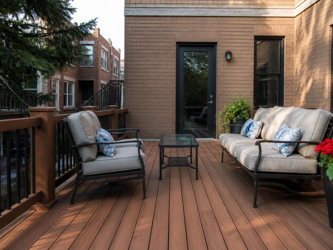 Finished wood deck with railing and seating behind a Chicago brick home